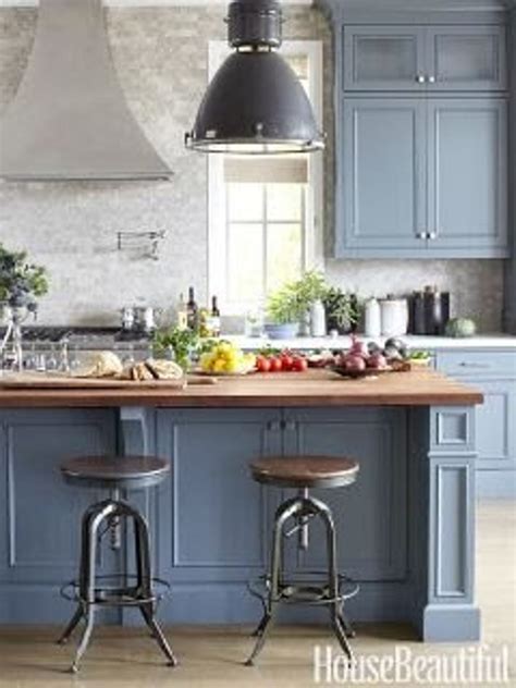 Blue and gray kitchen features gray raised panel cabinets adorned with brushed brass hardware paired with white quartz countertops and a blue mediterranean style mosaic tile backsplash, fireclay grandola tile, that goes up to the cieling. The Perfect Shade of Blue for a Kitchen? | Blue gray ...