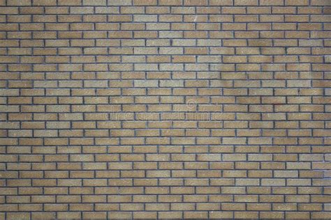 Brick Wall Of Gray And Yellow Bricks Rough Surface Texture Stock Photo