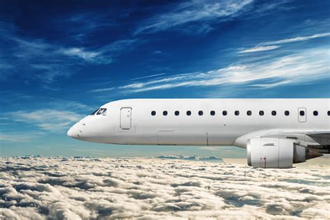 Side View Of A Commercial Airplane Flying Stock Photo Download Image