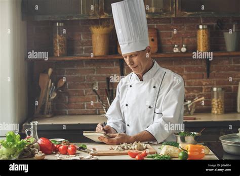 Mature Man Professional Chef Cooking Meal Indoors Stock Photo Alamy