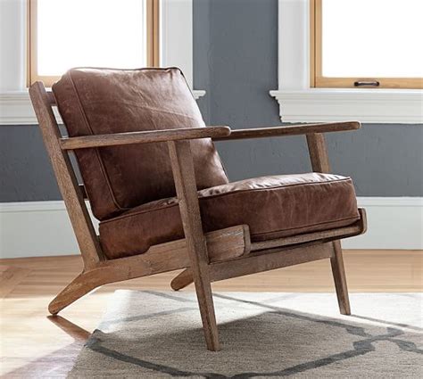 Holly is an armchair made up of ashwood and coloured leather. Raylan Leather Armchair | Pottery Barn