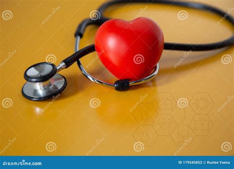 Stethoscope Doctors And Red Heart Cardiology Placed On A Yellow Table
