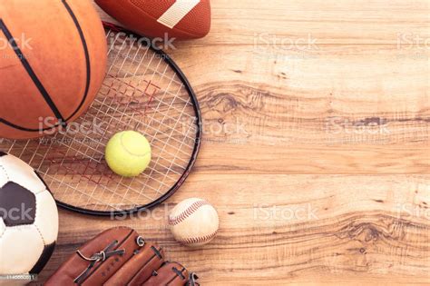 Various Sports Equipment Balls On Wooden Background Stock Photo