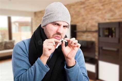 Young Man Breaking Cigarette In Two Pieces Stock Image Image Of