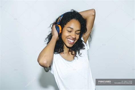 Portrait Of Happy Young Woman Listening Music With Headphones — High