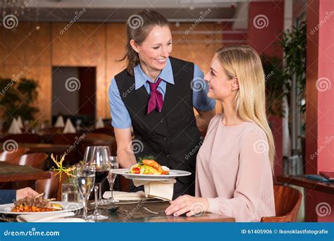 Waitress Serving The Meal To Guest In Restaurant Stock Photo Image Of