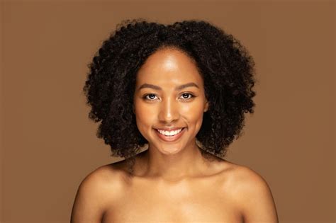 Premium Photo Attractive Black Woman With Bushy Hair Posing Naked On Brown