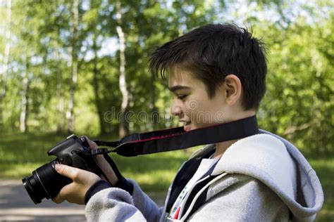 Portrait Of A Young Photographer In Profile With A Camera Stock Image