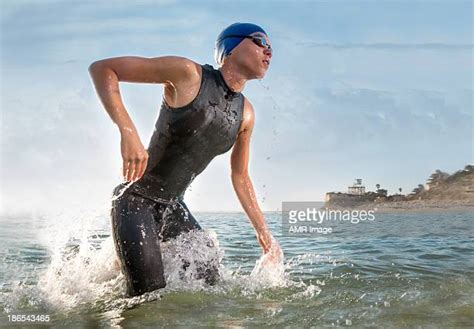 woman wetsuit running photos and premium high res pictures getty images