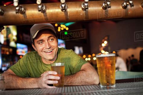 Caucasian Man Drinking Beer In Bar Stock Photo Dissolve