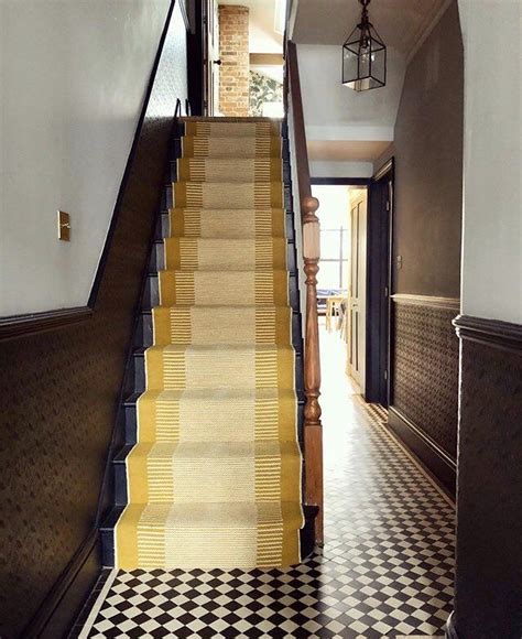 The Stairs Are Lined With Yellow And Black Checkerboard Tiles Along