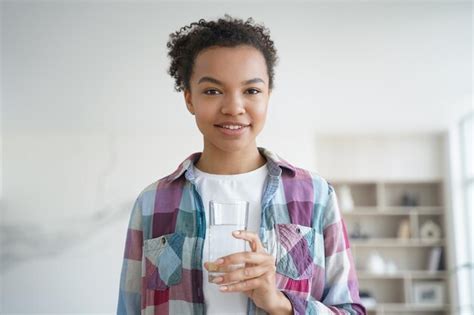 Premium Photo African American Girl Holds Glass Of Purified Water