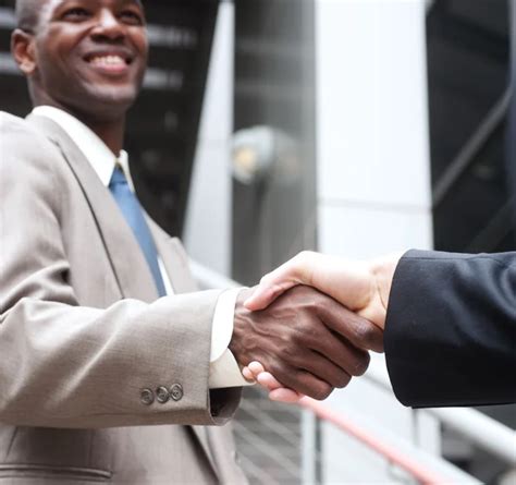 African American Businessman Shaking Hands With Caucasian Busine