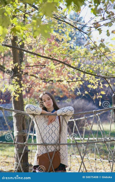 Beautiful Young Teenage Girl Posing Near A Rope Fence Stock Photo