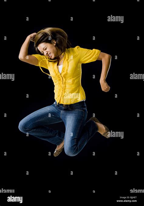 Woman Leaping With Arms Raised Stock Photo Alamy
