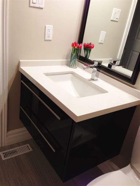 Sink Dark Cabinet And Mirror And Light Countertops Laundry In