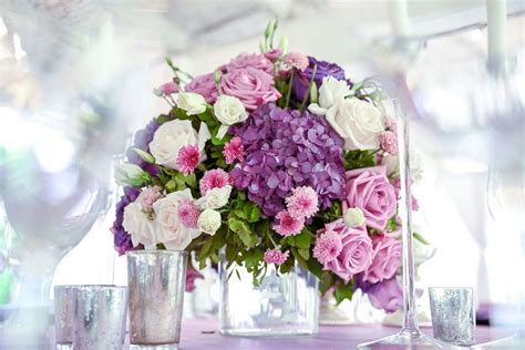 Beautiful Centrepieces With A Mixture Of Purple Pink And Whites