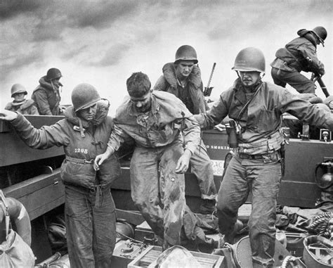 Photo Us Coast Guardsmen Assisting A Wounded Marine Into An Lcvp