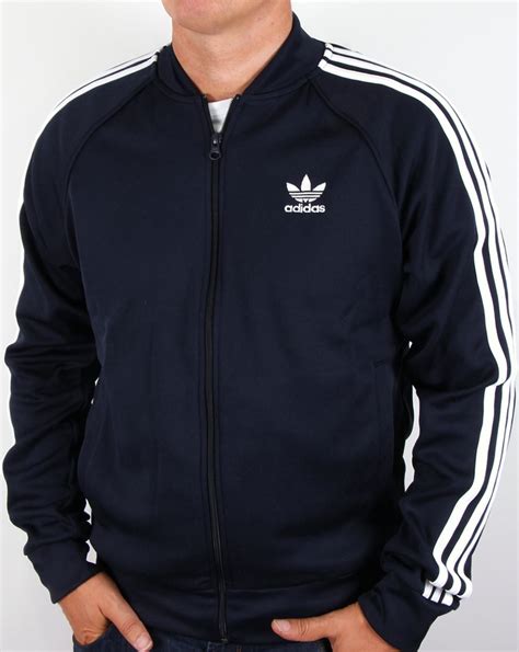 Nothing, but nothing, says classic vintage sportswear quite so loudly as the adidas three stripes down the sleeves of a jacket and the distinctive. Adidas Originals Superstar Track Top Legend Ink/White ...