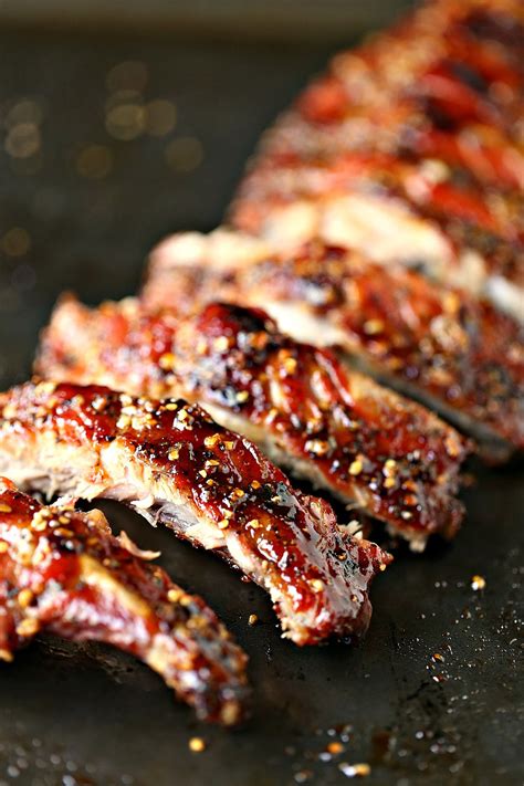 Ribs Covered In Bbq Sauce And Seasoning Sitting On A Grill Pan Ready To Be Cooked