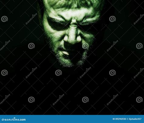 Low Key Portrait Of Evil Devil Bad Angry Face Of Man On A Bla Stock