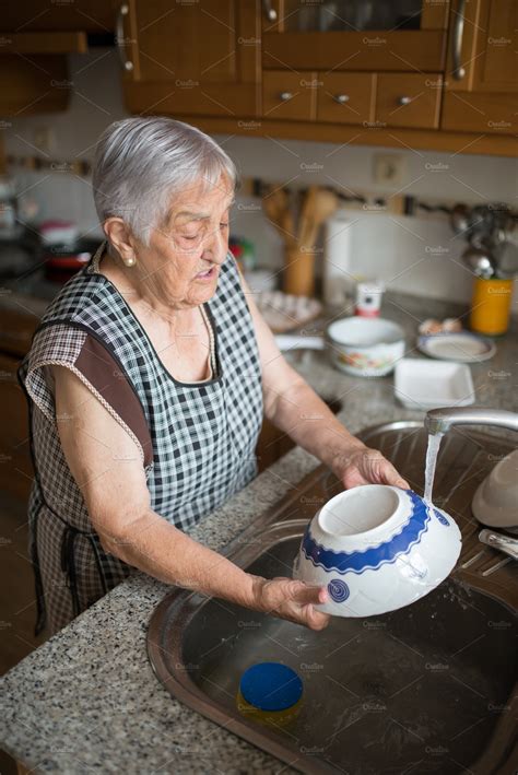 Elderly Woman Washing Dishes High Quality People Images ~ Creative Market