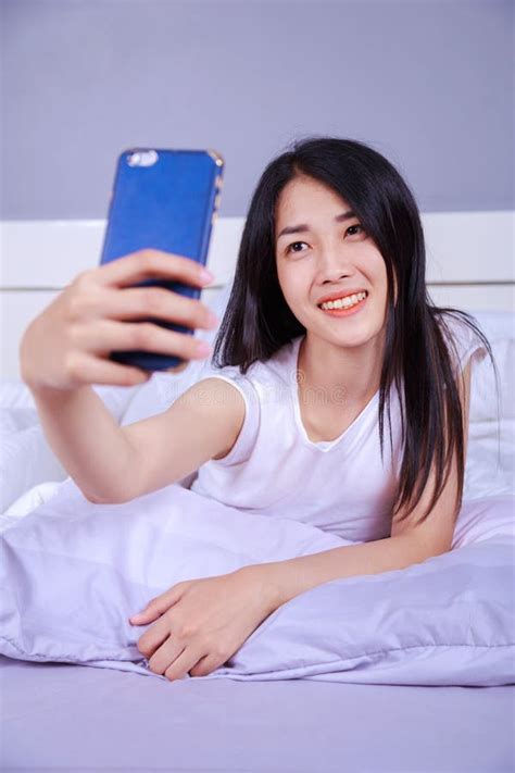 Woman Taking Selfie On Bed In Bedroom Stock Image Image Of Relax Pillow 102416089