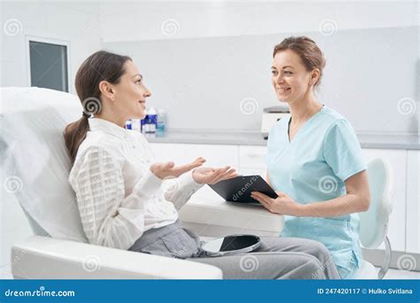 Woman Having Consultation With Cosmetologist In Beauty Clinic Stock