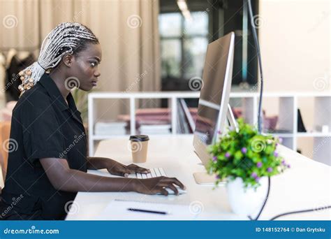 Smiling African American Young Woman Accountant Using Computer In