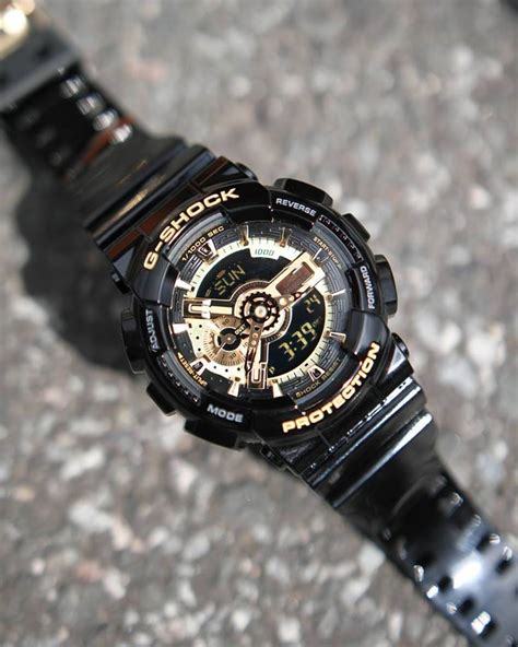 Black resin band analog and digital watch with gold face. G-Shock Eye Catching Black and Gold GA-110GB-1A & GD-X6900FB-1