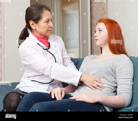 Female Doctor Examining The Teen Patient Stock Photo Alamy