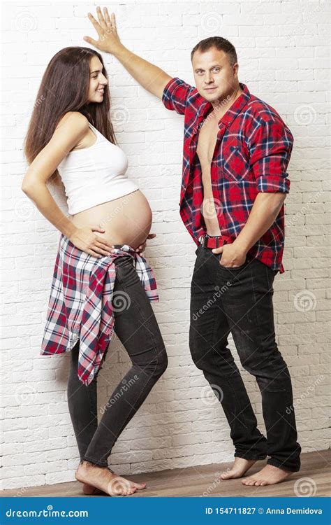 Beautiful Pregnant Couple Smiling And Hugging Love And Tenderness In Anticipation Of A Miracle