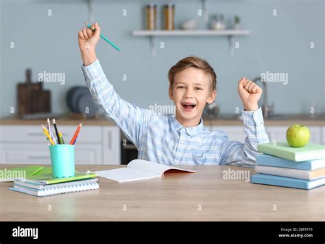 Happy Little Boy With His Homework Done At Table Stock Photo Alamy
