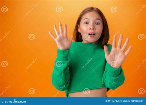 Photo Of Worried Nervous Teen Girl Afraid Of Something Against Orange Background Stock Image
