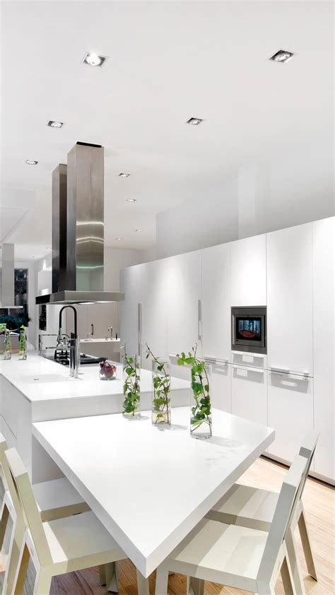 White farmhouse kitchen design with wooden backsplash and white cabinets. Kitchen Design. | Light & Life | Arkoslight