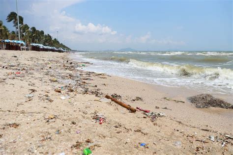 Low Angle View Image Of Empty Plastic Water Bottle On Dirty Beach Filled With Plastic Pollution