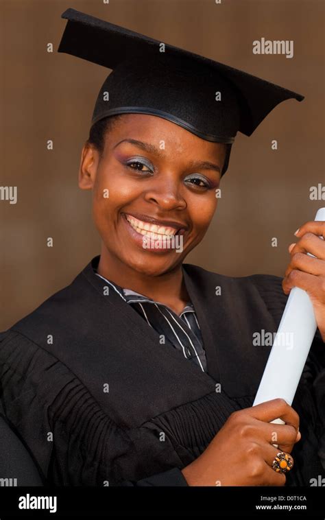 African American College Student Graduating With Mortarboard And Degree