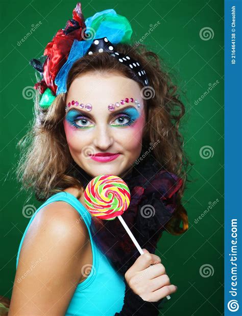 Portrait Of Young Woman In Carnaval Dress With Creative Make Up Holding