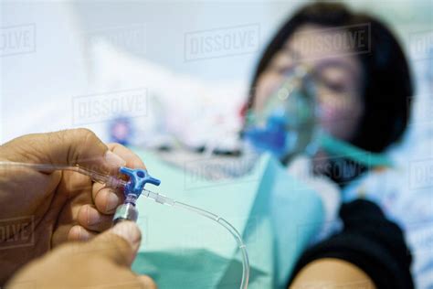 Doctor Adjusting Patients Iv Drip Cropped Stock Photo Dissolve