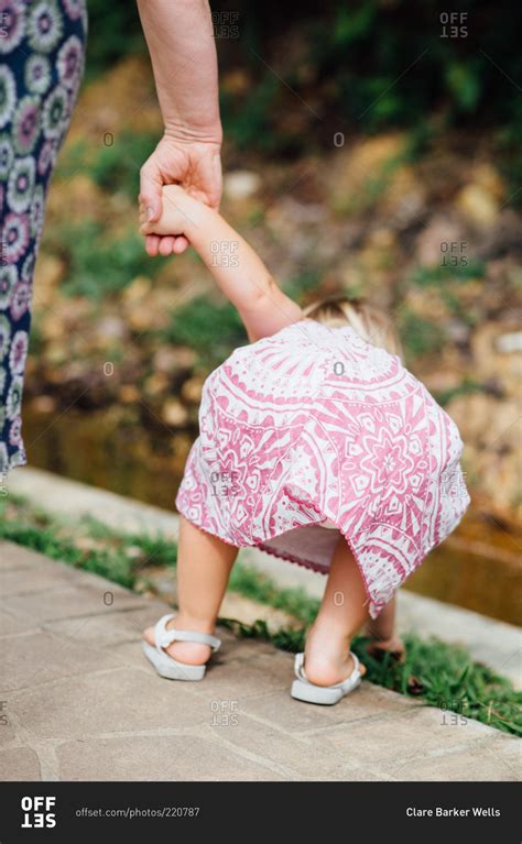 Back View Of Little Girl Bending Down Stock Photo Offset