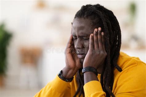 Closeup Shot Of Stressed Black Young Man Suffering From Headache At