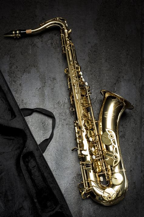 Brass Saxophone On Gray Table Near Black Bag · Free Stock Photo