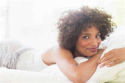 Portrait Of Woman Lying On Bed Stock Photo Dissolve