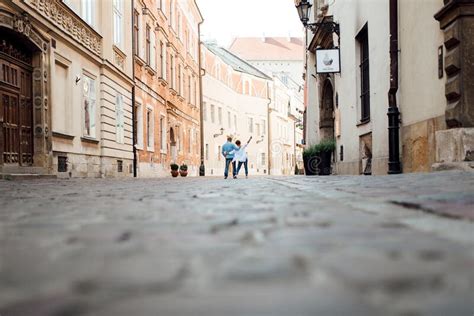 Guy And A Girl Happily Walk In The Morning On The Empty Streets Stock