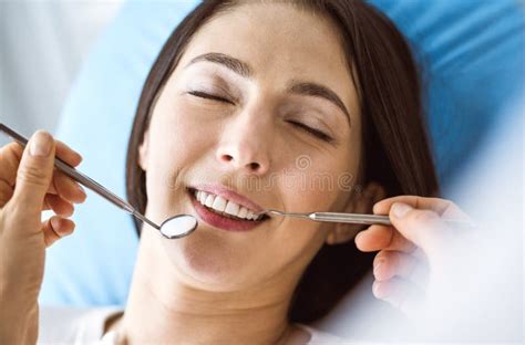 Smiling Brunette Woman Being Examined By Dentist At Dental Clinic