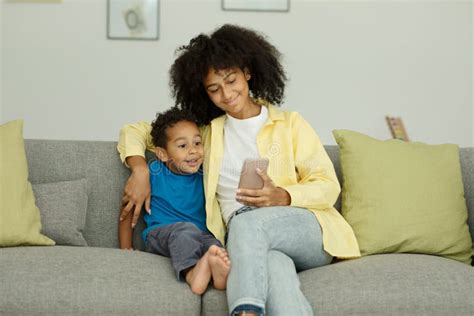Happy Excited Black Mom And Little Son With Smartphone Celebrate