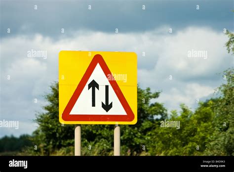 Road Sign Warning Of Two Way Traffic Straight Ahead