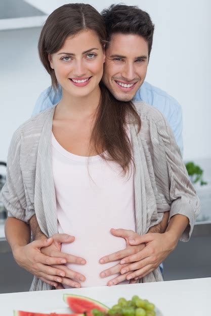 Premium Photo Man Holding The Belly Of His Pregnant Wife In The Kitchen