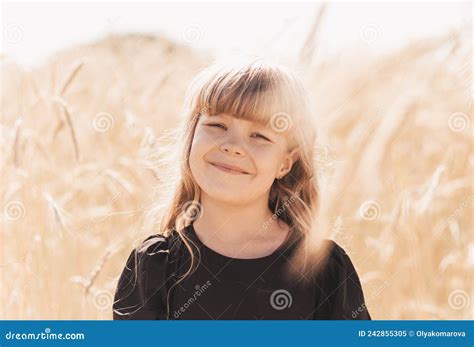 Beautiful Little Girl In A Black Dress At Sunset In A Field Beautiful