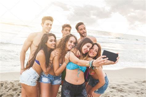 Multiracial Group Of Friends Taking Selfie On The Beach Stock Photo